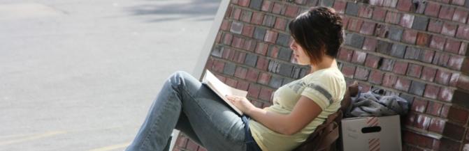 Student Reading Book Outside